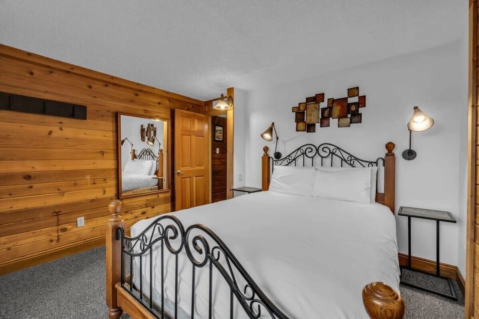 Comfortable queen-size bed with TV, and ample storage space in the main bedroom