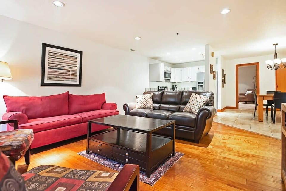 Relax in the family room with a leather sofa, a plush sofa, armchair seating, an indoor wood fireplace, and a flat-screen TV