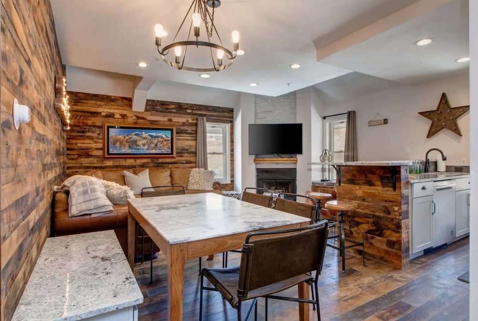 The open-concept living/dining/kitchen area in this one-of-a-kind condo with stylish, inviting decor gives the vibe of a boutique hotel while offering all of the comforts of home.
