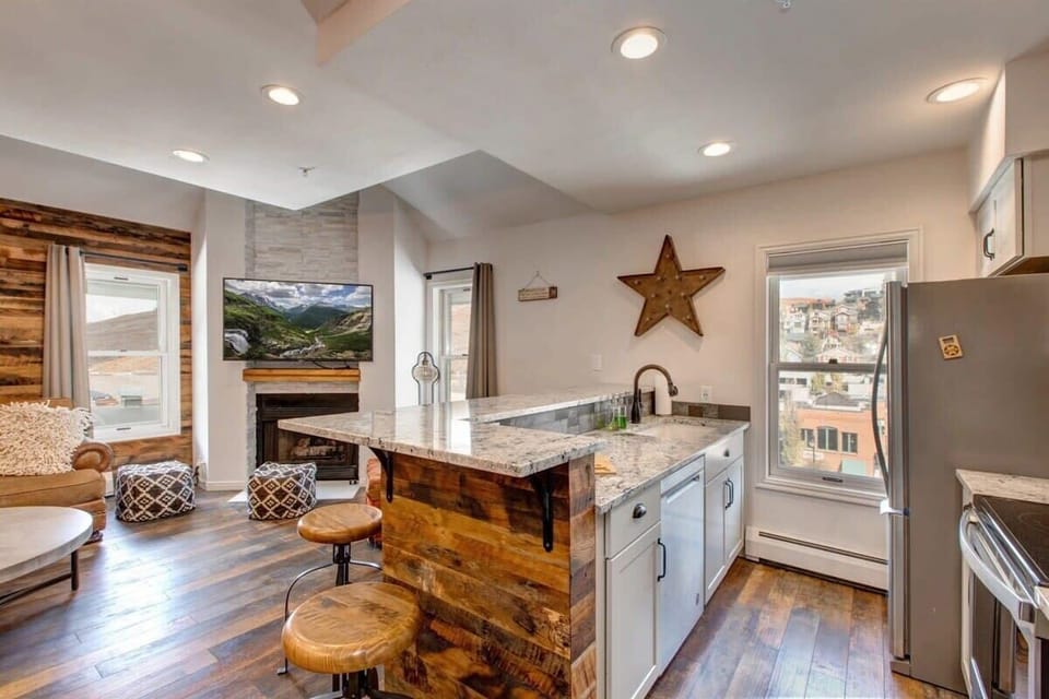 This bright and lovely kitchen features stainless steel appliances, ample storage space and views of historic Old Town as well as the living room’s flat-screen TV, making it easy to grab a snack without missing a thing.
