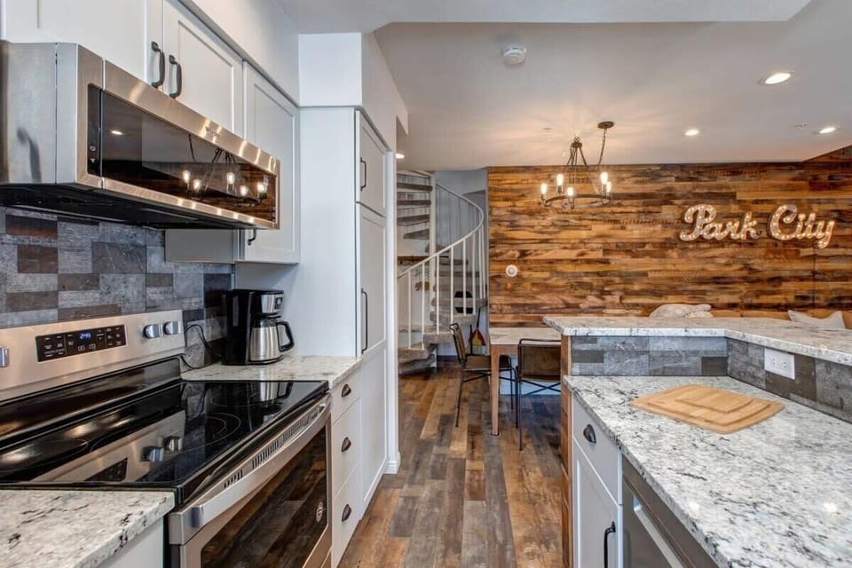 The view from the bright and lovely kitchen highlights its beautiful finishes, stainless steel appliances and close proximity to the dining area, with seating for six.