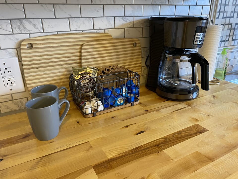 Coffee pot and complimentary coffee and creamer