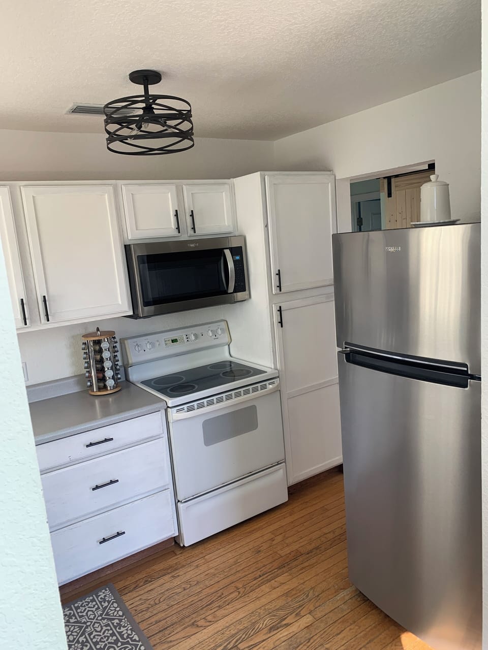 Kitchen is equipped with new microwave, refrigerator and dishwasher