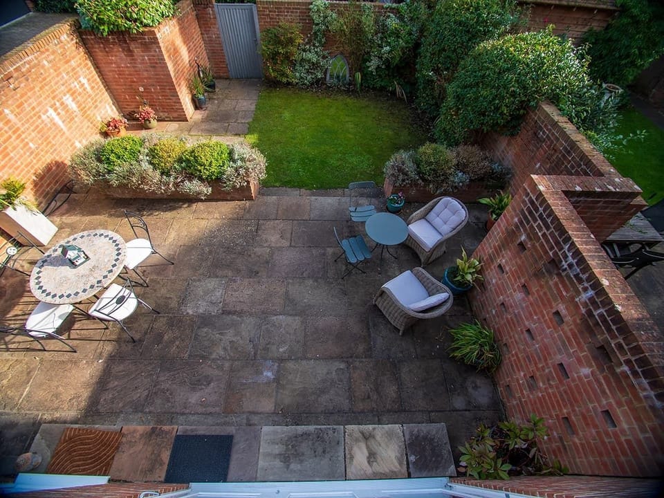 Walled garden with back gate leading to reserved off-street parking for 1 car