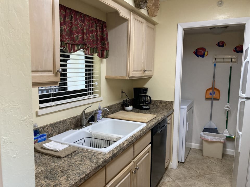 Galley kitchen and laundry with full size washer and dryer