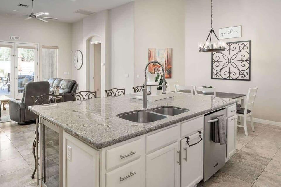 The large kitchen island also includes a built in wine fridge, sink, and dishwasher.