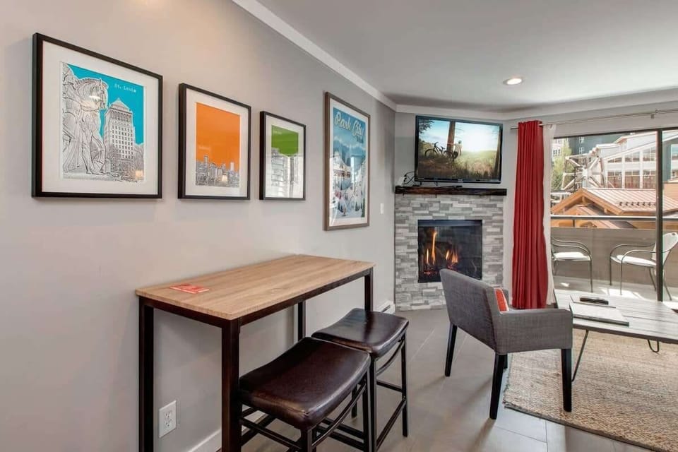 This charming dining area is conveniently located just off of the kitchen and can double as a desk/work space while keeping you within view of the fireplace and patio, with its mountain village views.