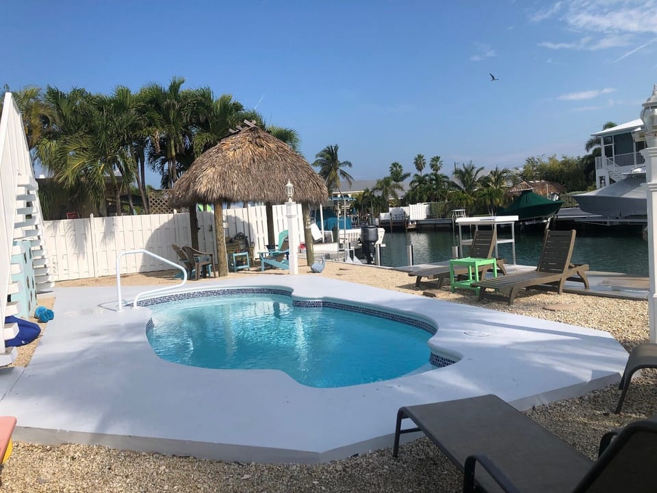 Lovely pool , tiki and dock