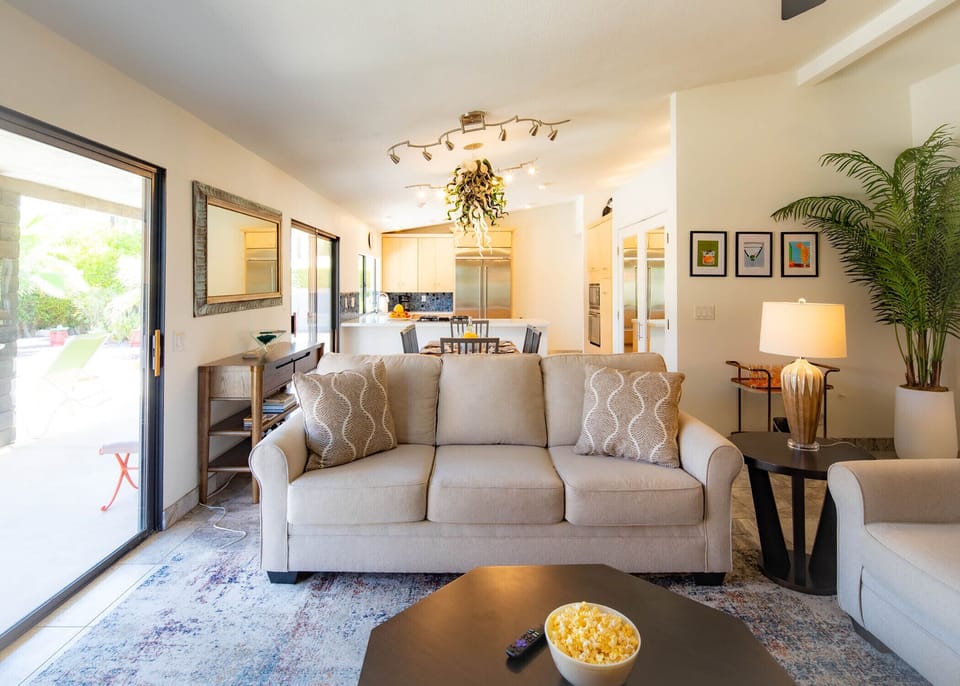 Open concept living room with pool views