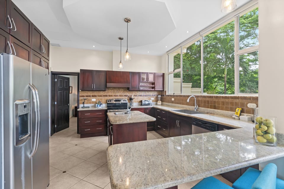 The large kitchen is well-equipped and features and island and breakfast bar.