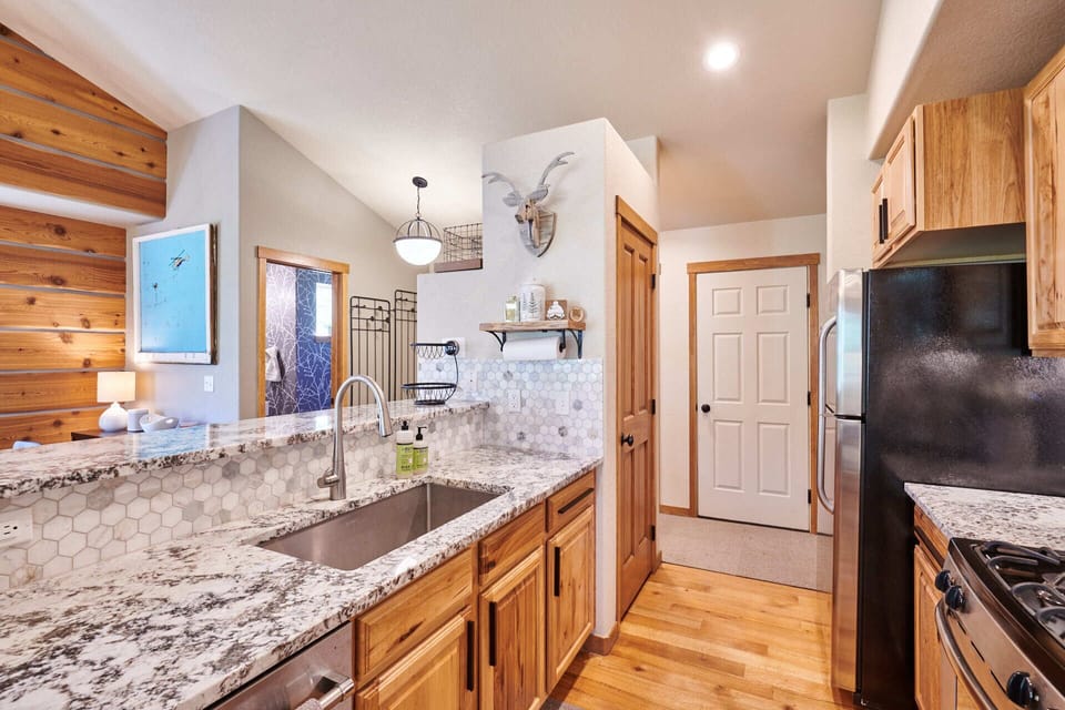 Fully stocked kitchen with dishwasher, fridge, gas range and microwave