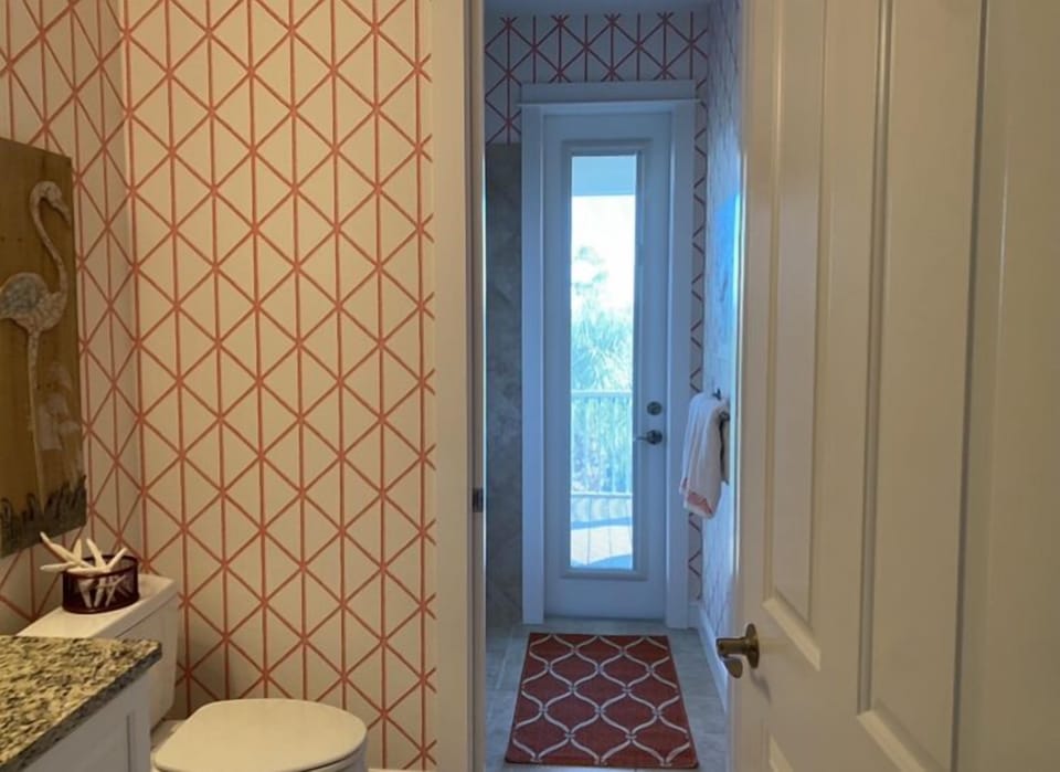 Guest bathroom with shower/tub combination and access to back porch