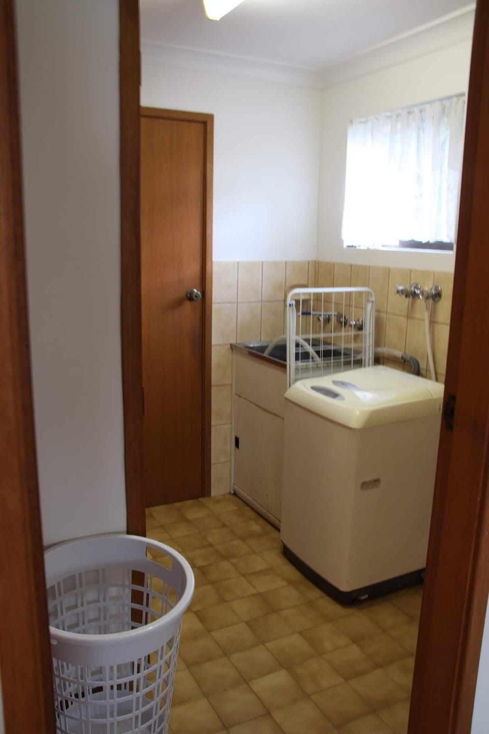 Laundry with washing machine. The clothes dryer is located in the garage.