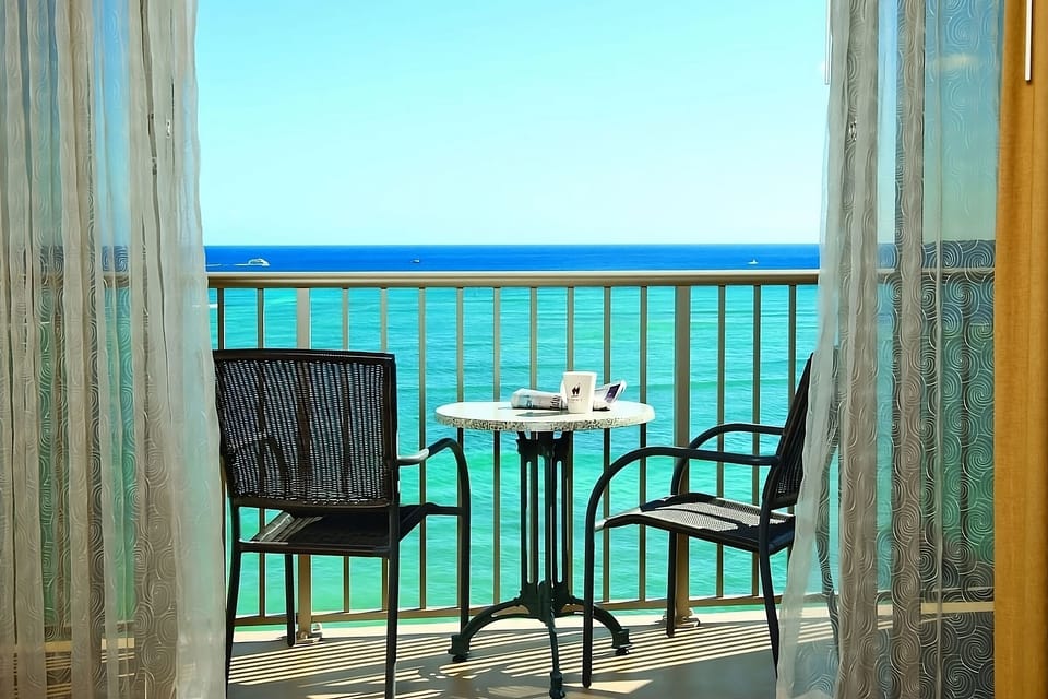 Step outside and savor sunrise coffee over turquoise waves.