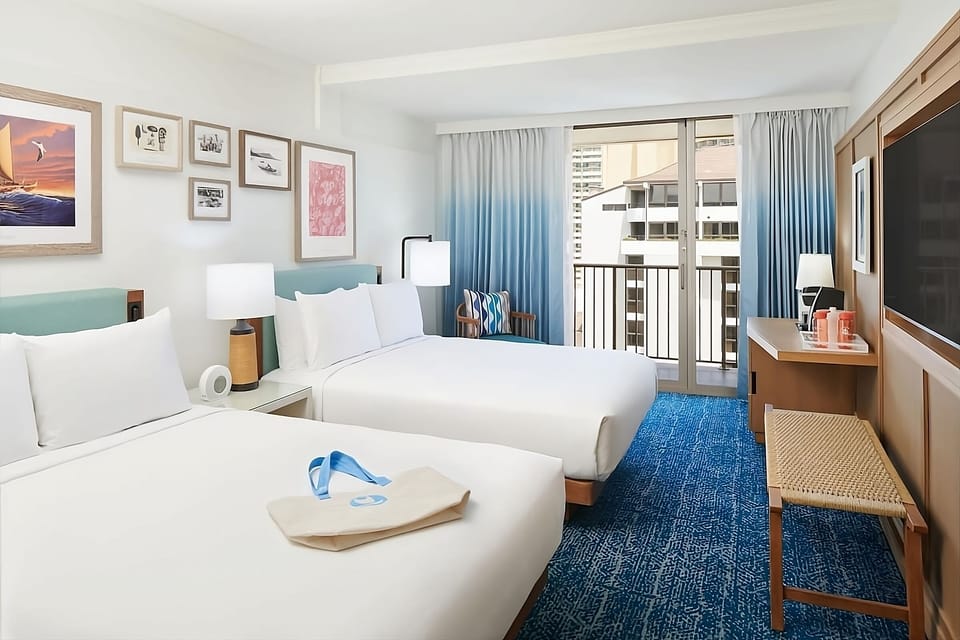 Unwind in a bright room with balcony breezes and plush beds.