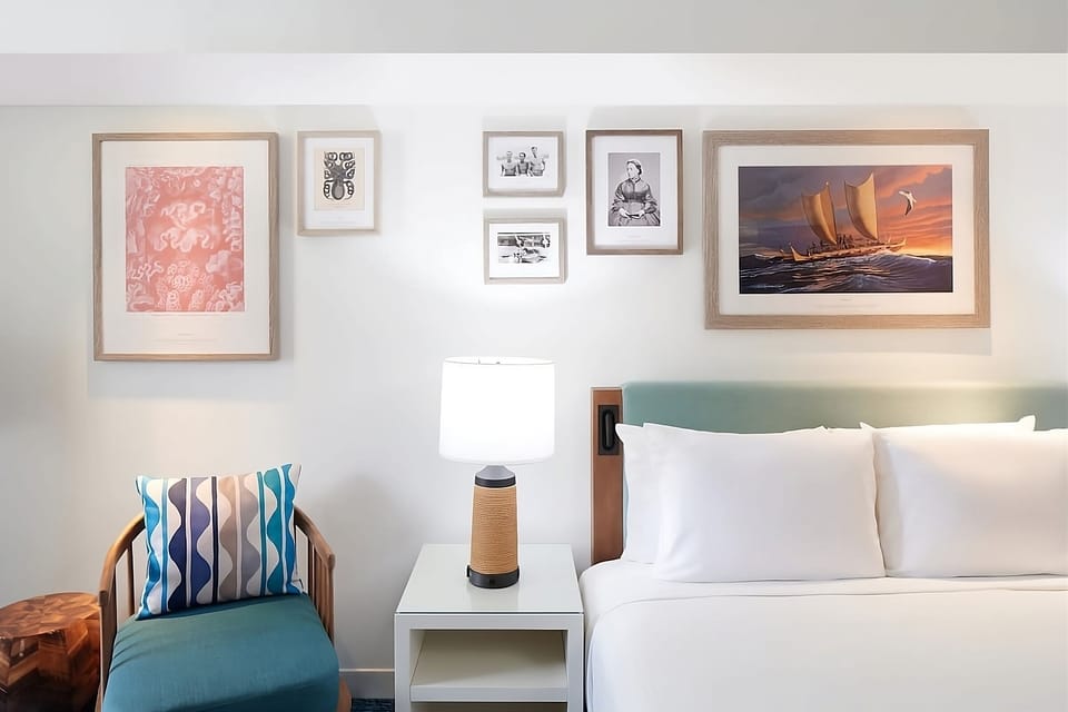 Sink into soft pillows beneath curated island-inspired artwork.