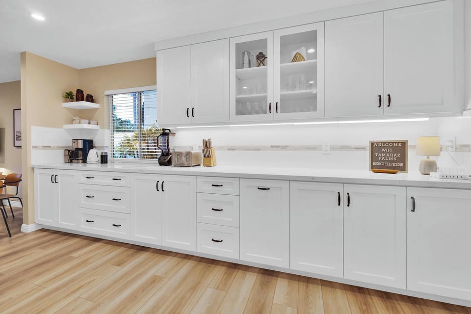 Enjoy alll the kitchen amenities of home and more including: 12-cup Cusinart coffee maker, Nespresso milk frother, french press, Cusinart whole bean coffee grinder, electric tea kettle, Ninja blender and electronics charging station.