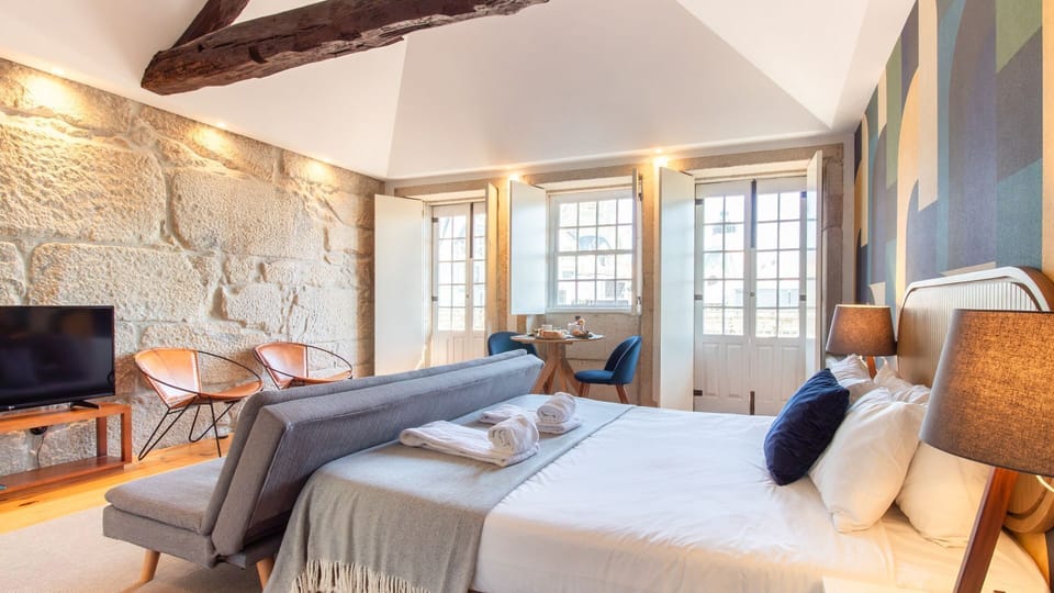 Settle into this thoughtfully designed studio, where historic stone walls meet modern comfort and an inviting bed promises restful nights. Wake up to natural light filtering through the windows, ready to explore the city.