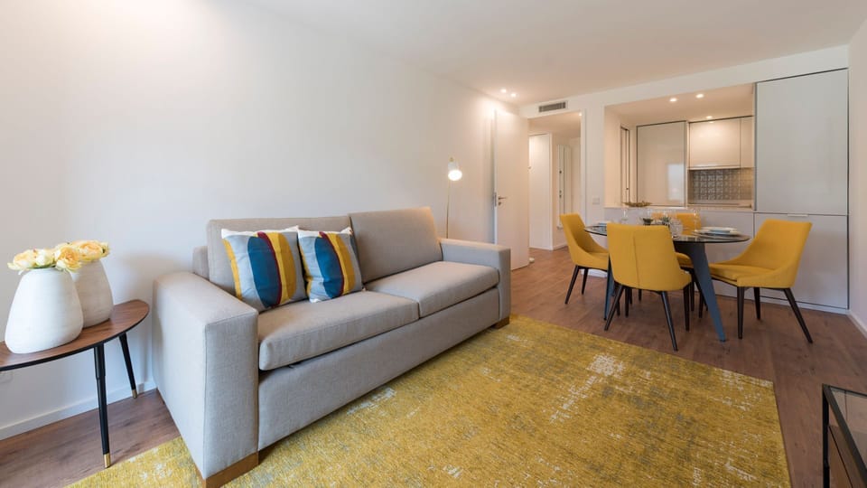 Relax in this inviting living space, where modern design meets comfort, with an open-plan dining area ready for meals.
#LivingRoom #ModernDesign #LovelyStay