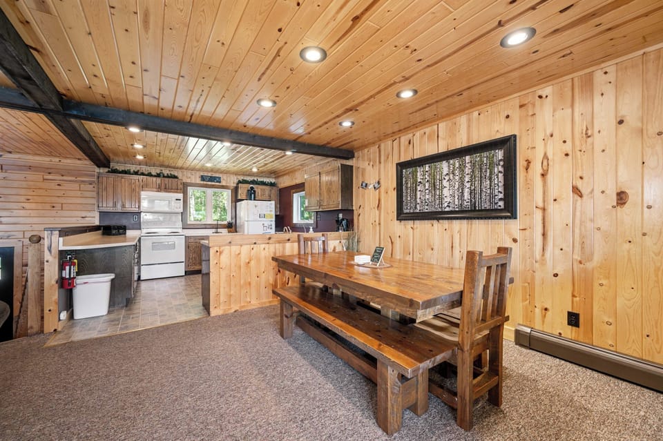 Large open concept kitchen with big harvest table for gathering