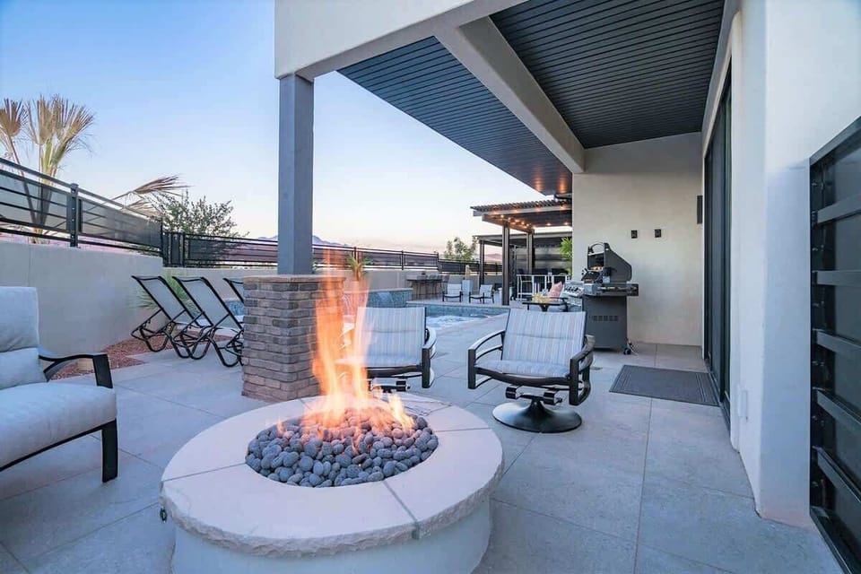 Poolside gas fire pit with cushioned seating