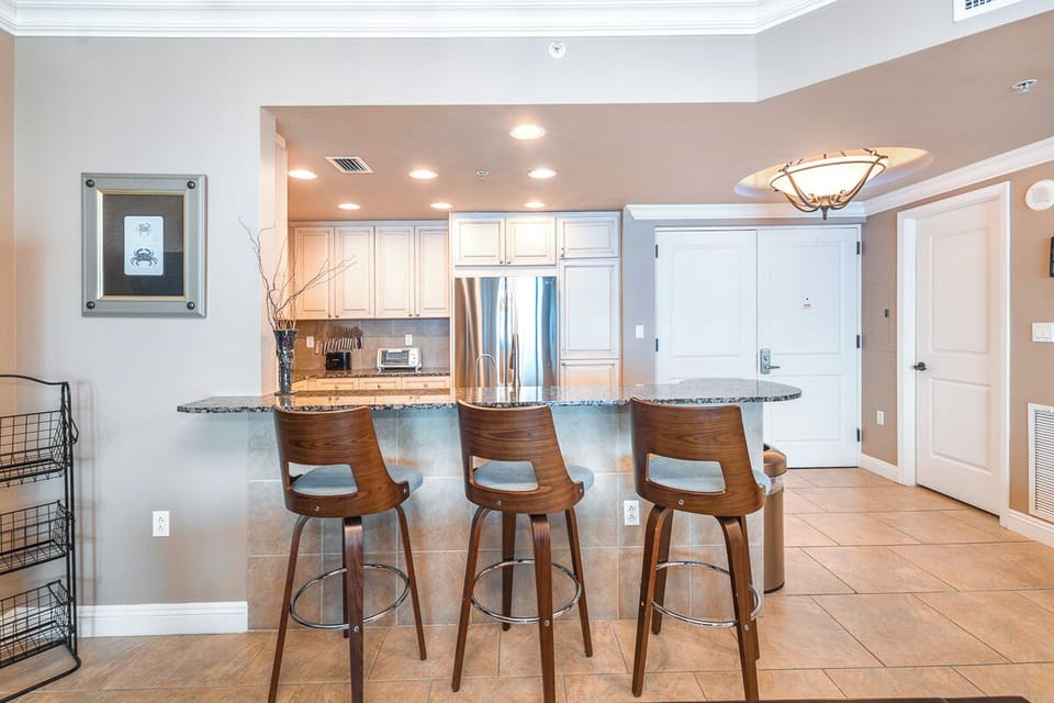 Pull up a seat at this sleek granite-topped breakfast bar where three modern bar stools invite you to savor your morning coffee or chat with fellow travelers in this open, light-filled space.