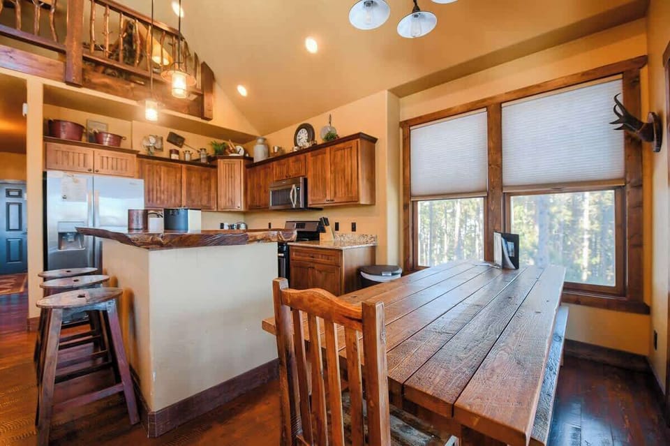 Kitchen table with seating for 8, as well as the seating for 3 at the breakfast bar