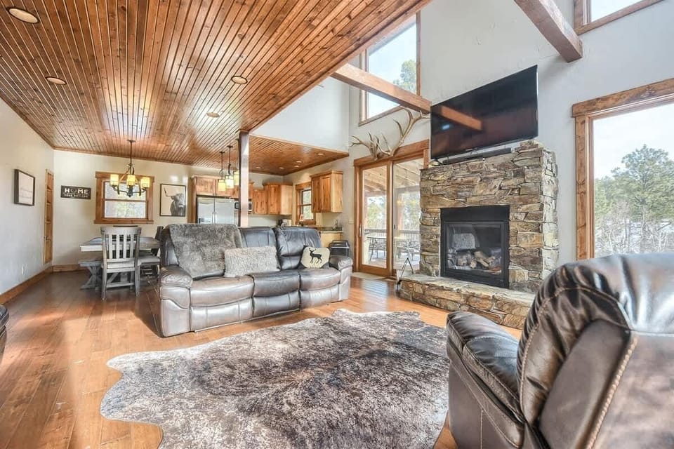 Main floor living room with gas fireplace, and large flat screen TV