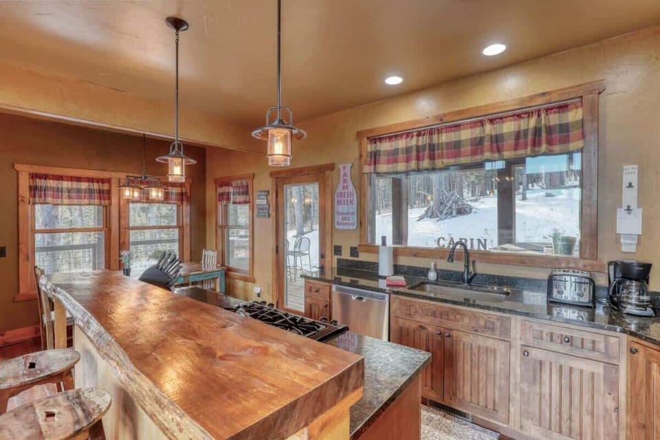 Open concept kitchen and dining room with access to outside deck 