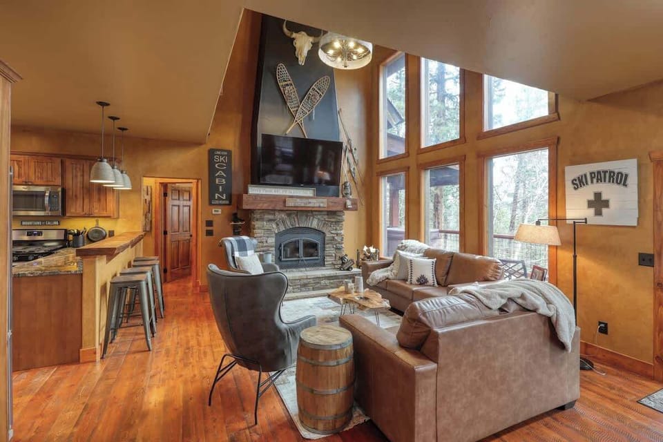 Main level living room with cozy wood burning fireplace