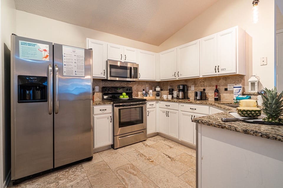 Fully equipped kitchen with stove, oven, fridge, & coffee area