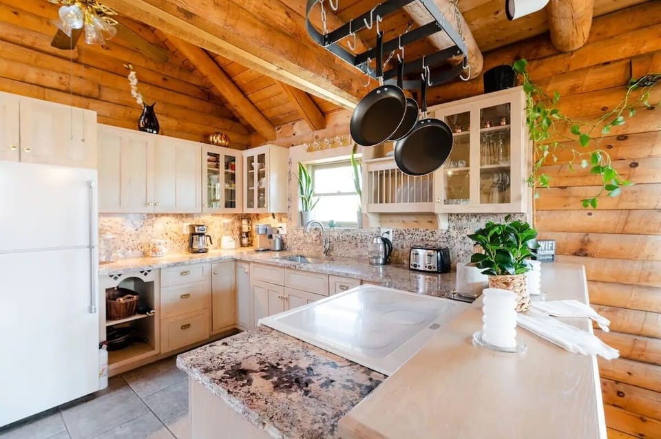 Rustic Redesigned Kitchen with Granite Countertop and Exposed Wood Beam Ceiling