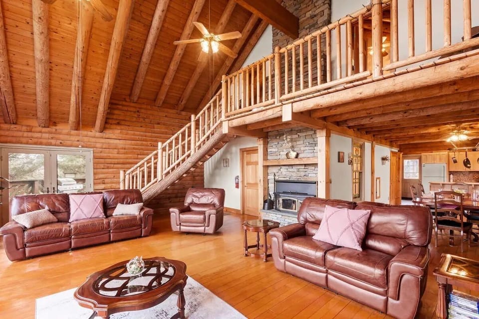 Relax by the wood burning Fireplace and view of custom made Wooden Staircase