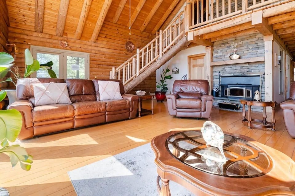 Relax by the wood burning Fireplace and view of custom made Wooden Staircase
