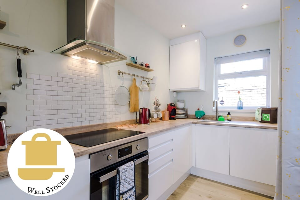 Open plan kitchen with all all cooking and cleaning appliances.