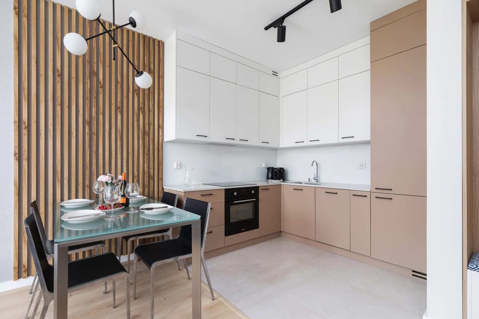 Sleek and functional kitchen space with light cabinetry, high-end appliances, and a compact layout. Perfect for culinary enthusiasts seeking efficiency and style.