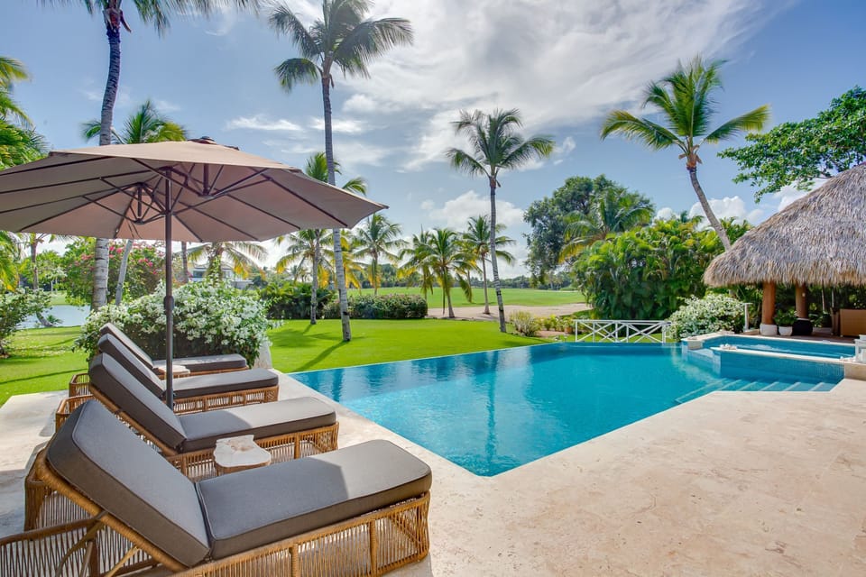 Pool area with hot tub, lake and golf views, outdoor living and a large garden