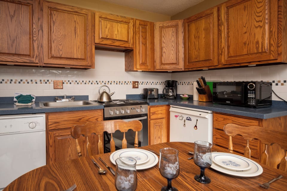 Your fully-equipped kitchen features warm oak cabinets, granite counters, and everything needed to prepare delicious meals during your stay.