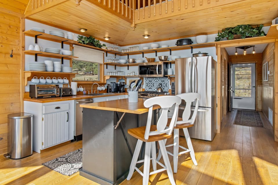 Sunlit kitchen with modern amenities and cozy wooden charm