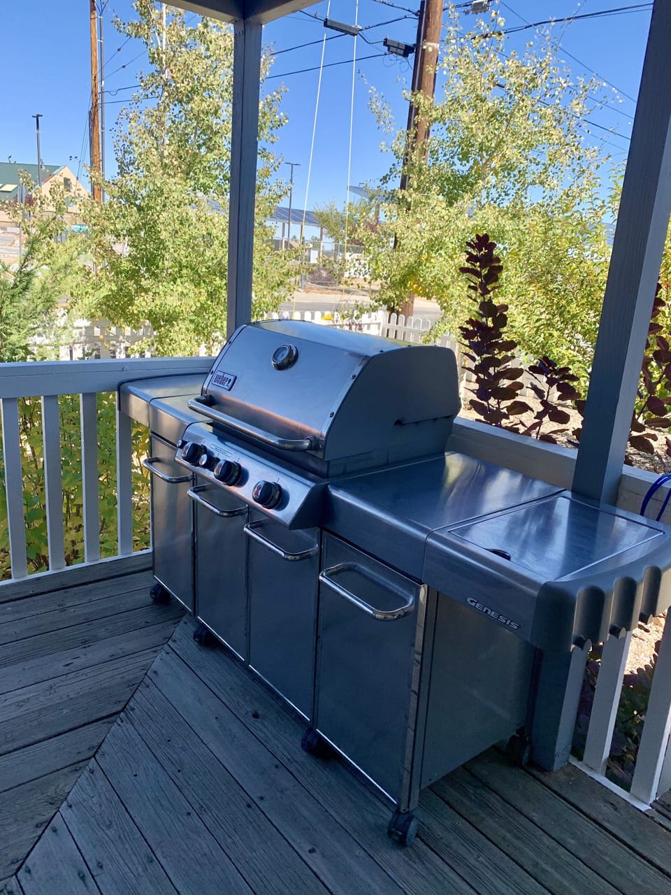 Weber propane grill on covered front porch