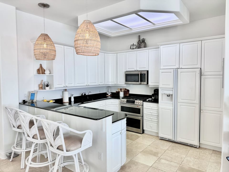 Kitchen on top floor. Double ovens, 6-burner gas range, microwave, dishwasher.