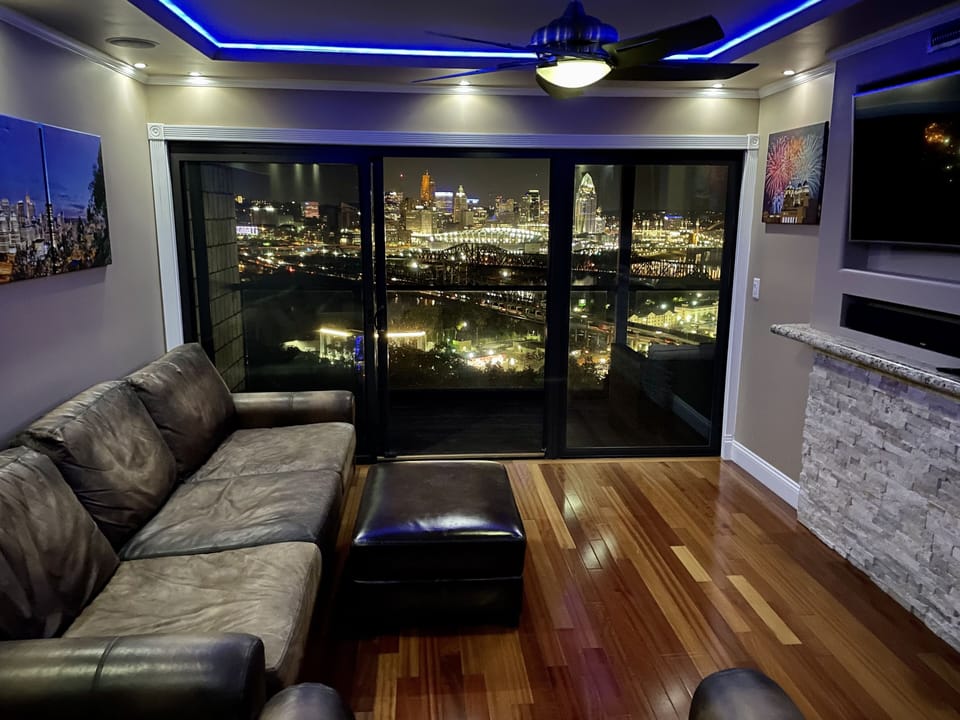 Pottery Barn leather couches, bourbon barrel tables, Samsung QLED smart tv 