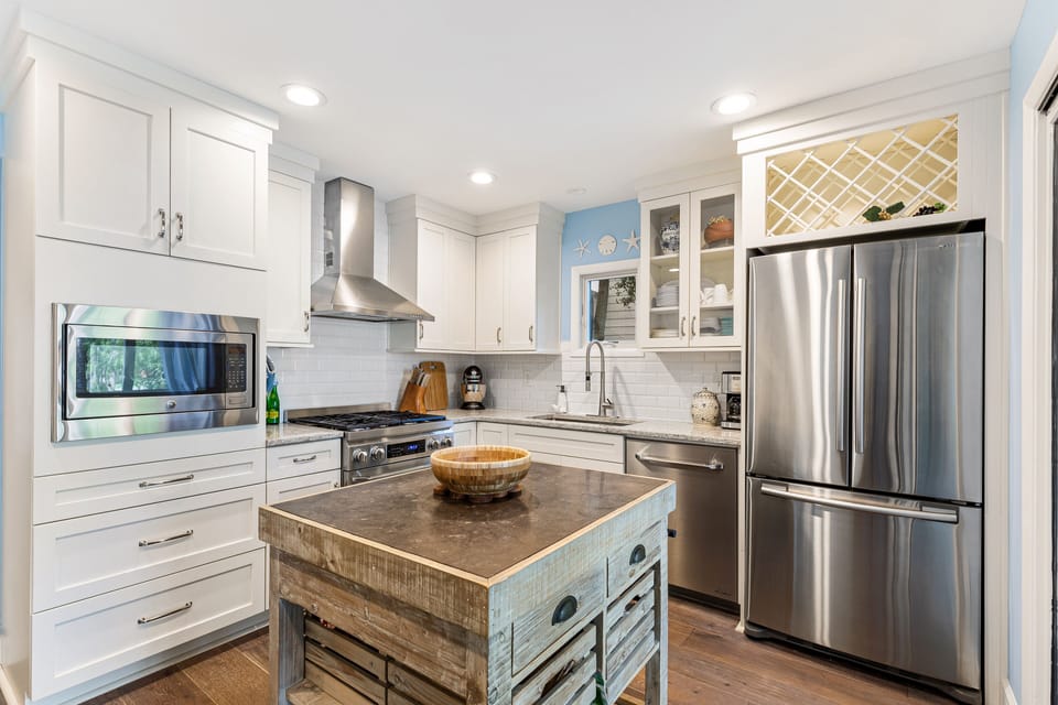 Fabulous kitchen with granite counters, white cabinetry,gas range and Dacor stainless appliances