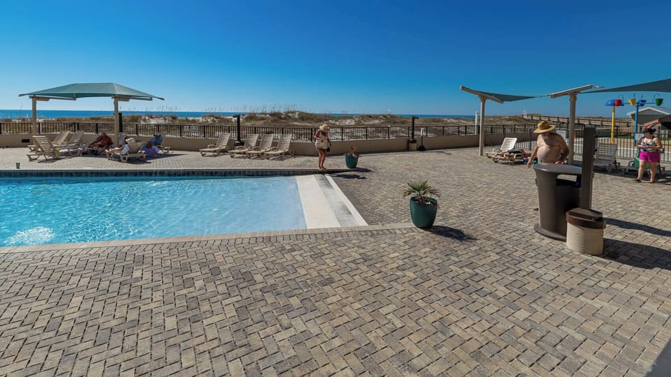 Inviting gradual entry pool with comfortable lounge chairs and a refreshing atmosphere, perfect for relaxation