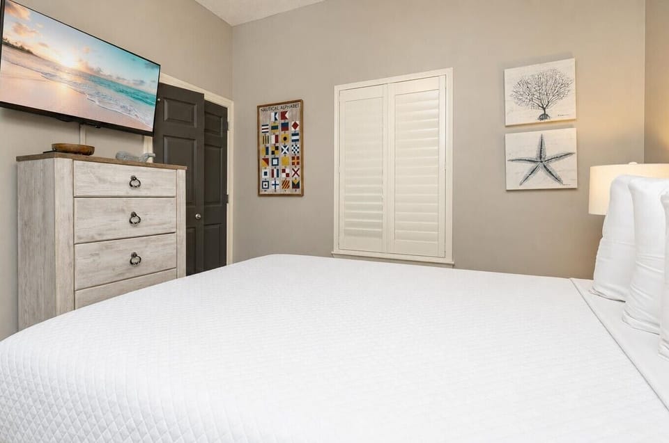 Unwind in this guest bedroom featuring a queen bed, tasteful decor, and a TV for your entertainment
