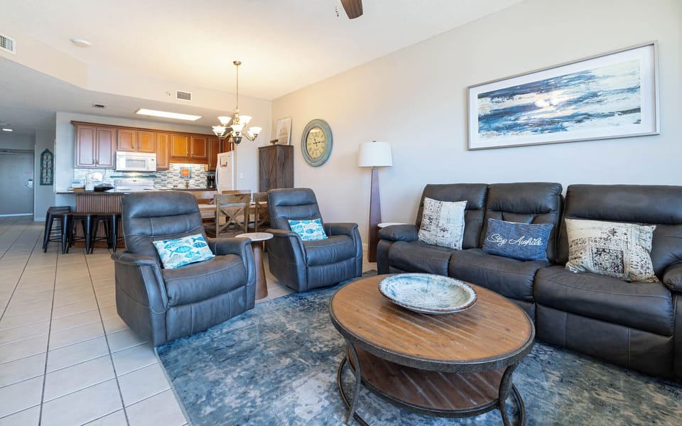 Comfortable living space, featuring a stylish coffee table and a view of the inviting kitchen