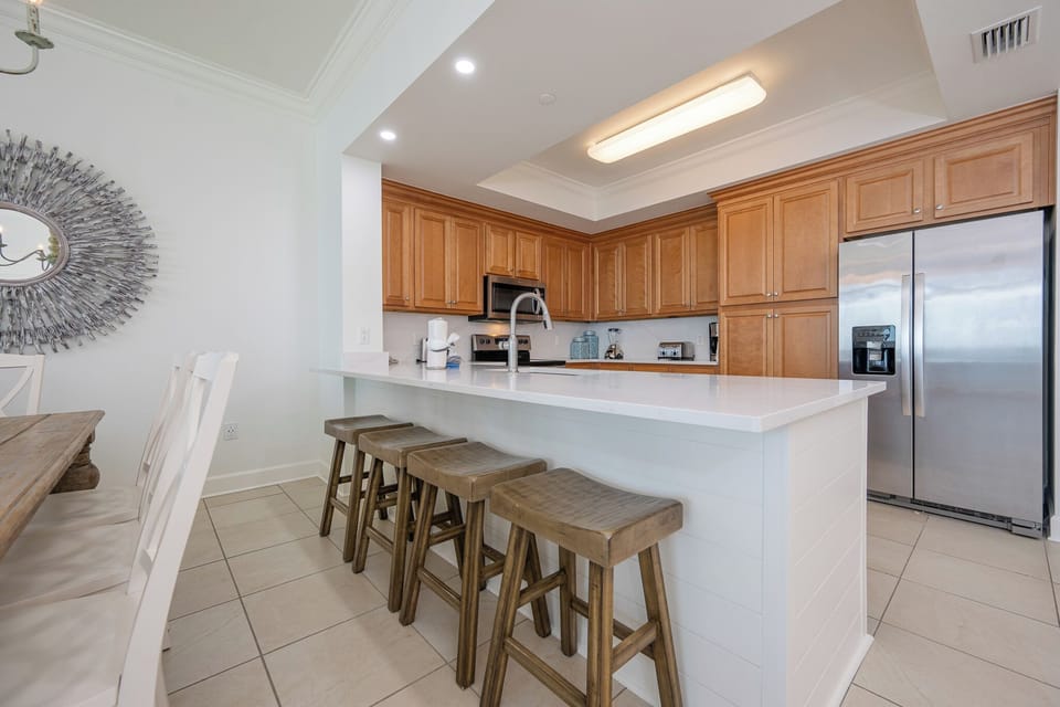 Pull up a wooden stool at the breakfast bar to chat and sip coffee while meals come together in the kitchen
