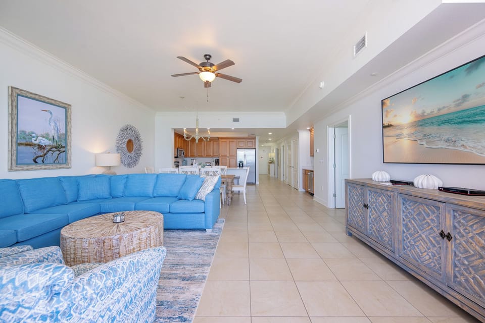 Soft patterned chairs invite you to unwind in the living room after a sun-filled day on the gulf coast