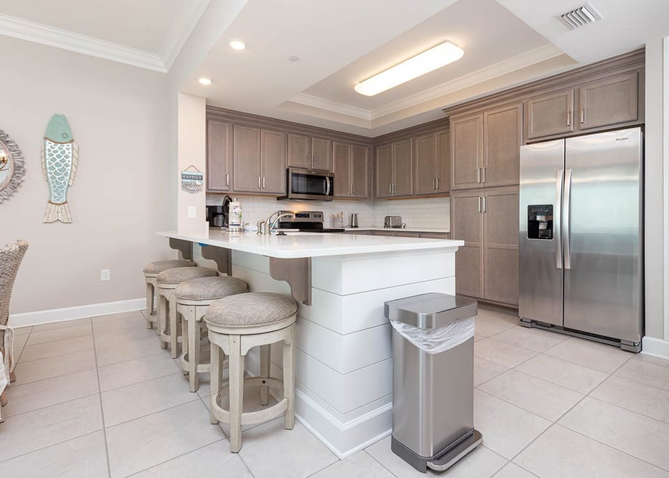Sip your morning coffee at the breakfast bar and get ready for a beach day in this stylish space