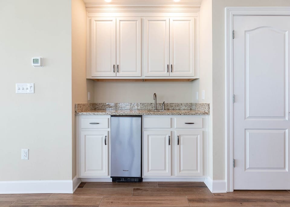 Mix and mingle at the wet bar, pouring chilled drinks to complement your beachside retreat